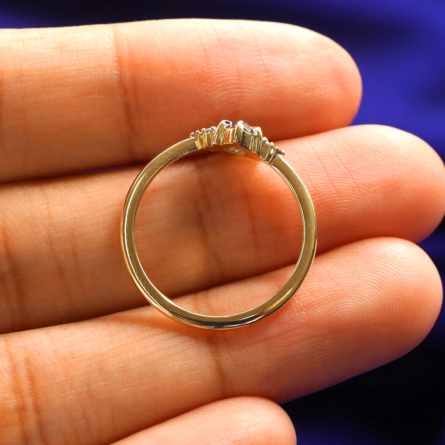 A Pear Salt and Pepper Diamond Ring in a model's hand showing the thickness of the band and the height of the ring