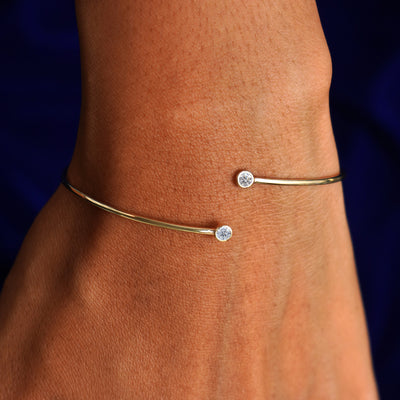 A model's wrist wearing a yellow gold Diamond Bypass Bracelet