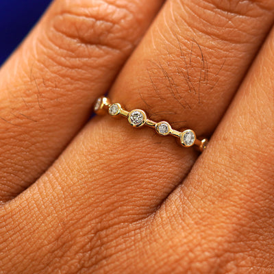 Close up view of a model's fingers wearing a 14k yellow gold Infinity Diamond Ring