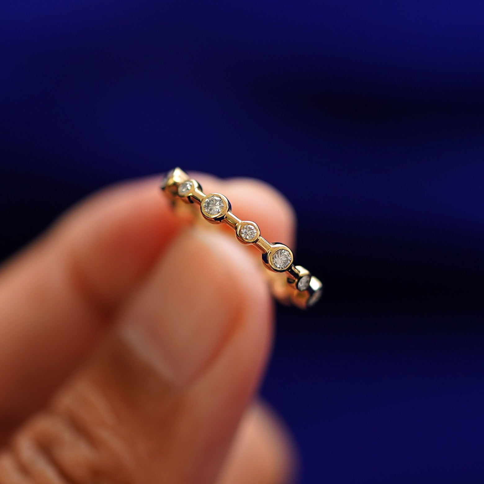 A model holding a Infinity Diamond Ring tilted to show the side of the ring