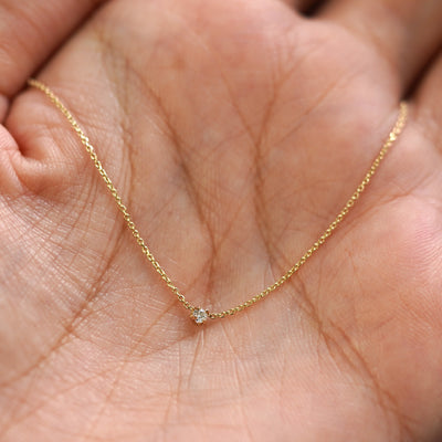 A yellow gold Diamond Cable Necklace draped on a model's palm