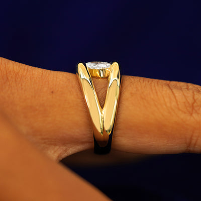 Side view of a Oval Lab Diamond Tension Ring on a model's finger to show details