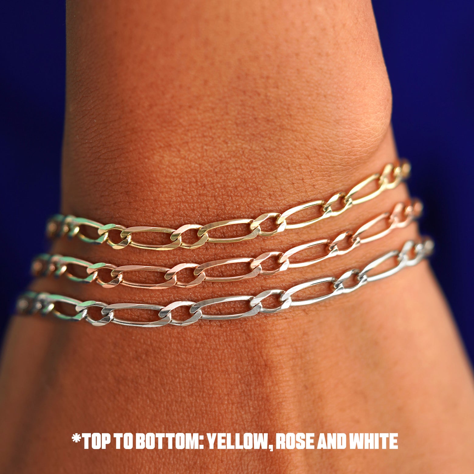 Close up view of a model's wrist wearing three versions of the One to One Bracelet in options of rose, yellow, and white gold