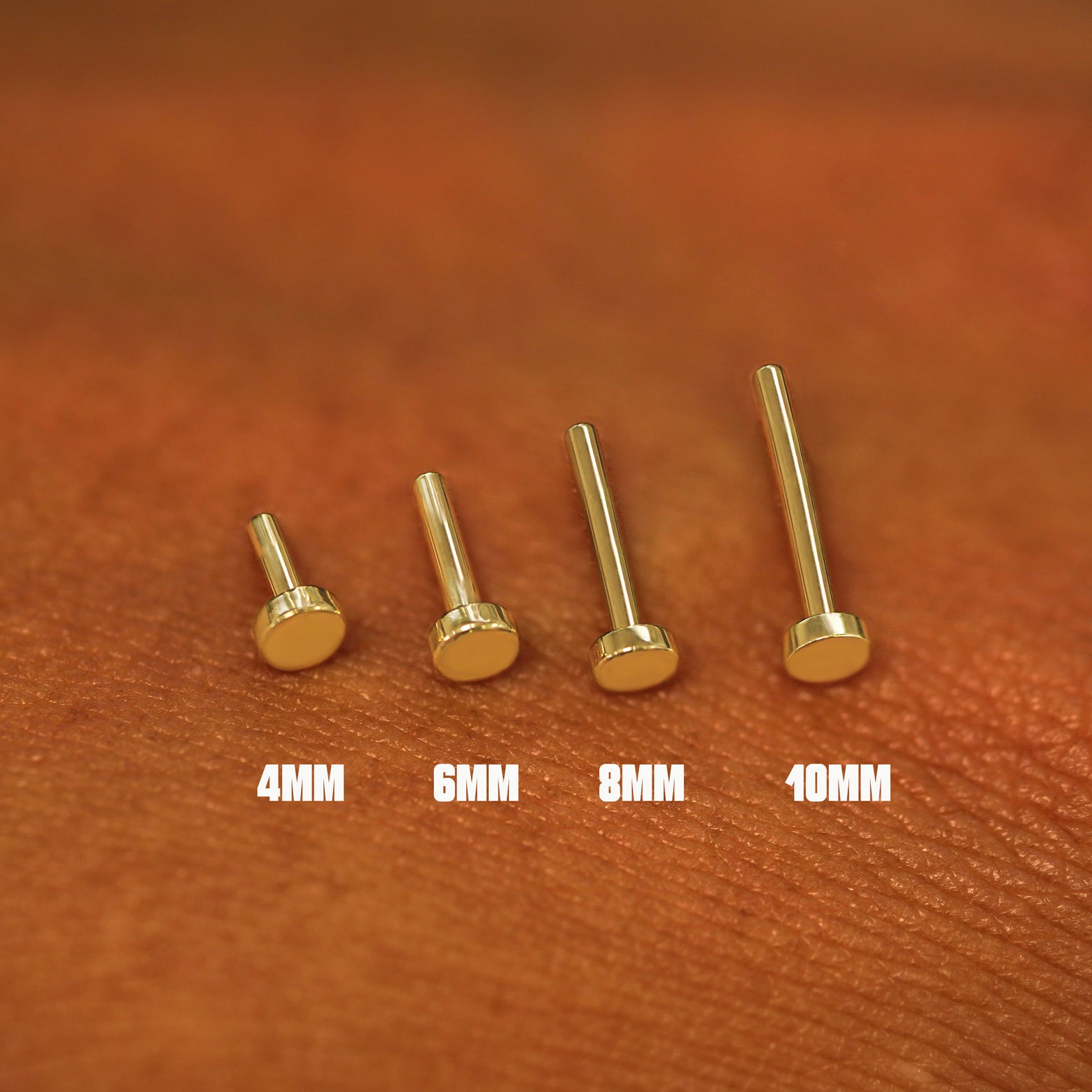 Four solid yellow gold flatback backings shown in options of 10mm, 8mm, 6mm and 4mm