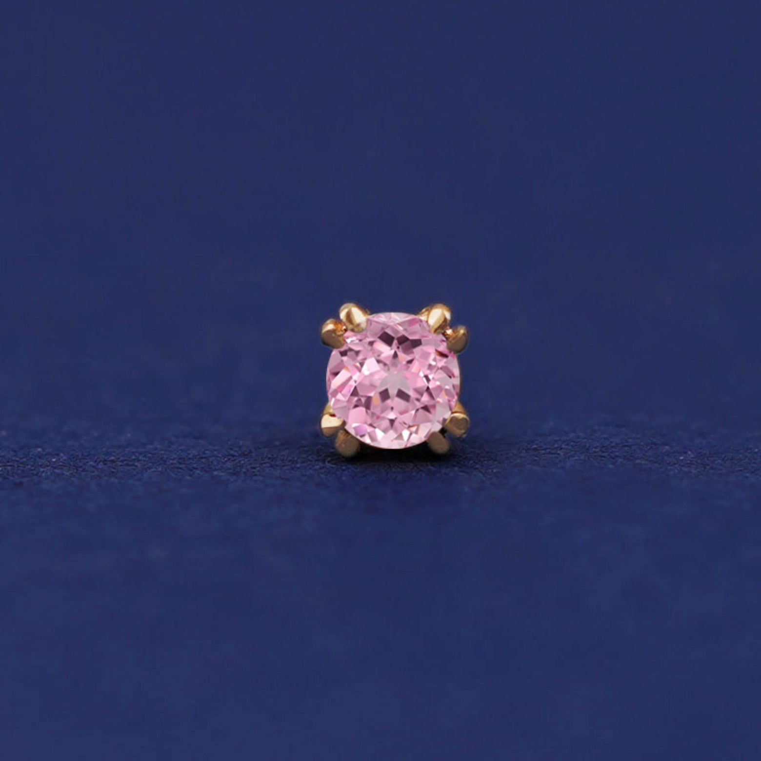 Front facing view of a 14k yellow gold Pink Sapphire Flatback Piercing