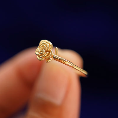 A model holding a Rose Ring tilted to show the rose and stem detailing