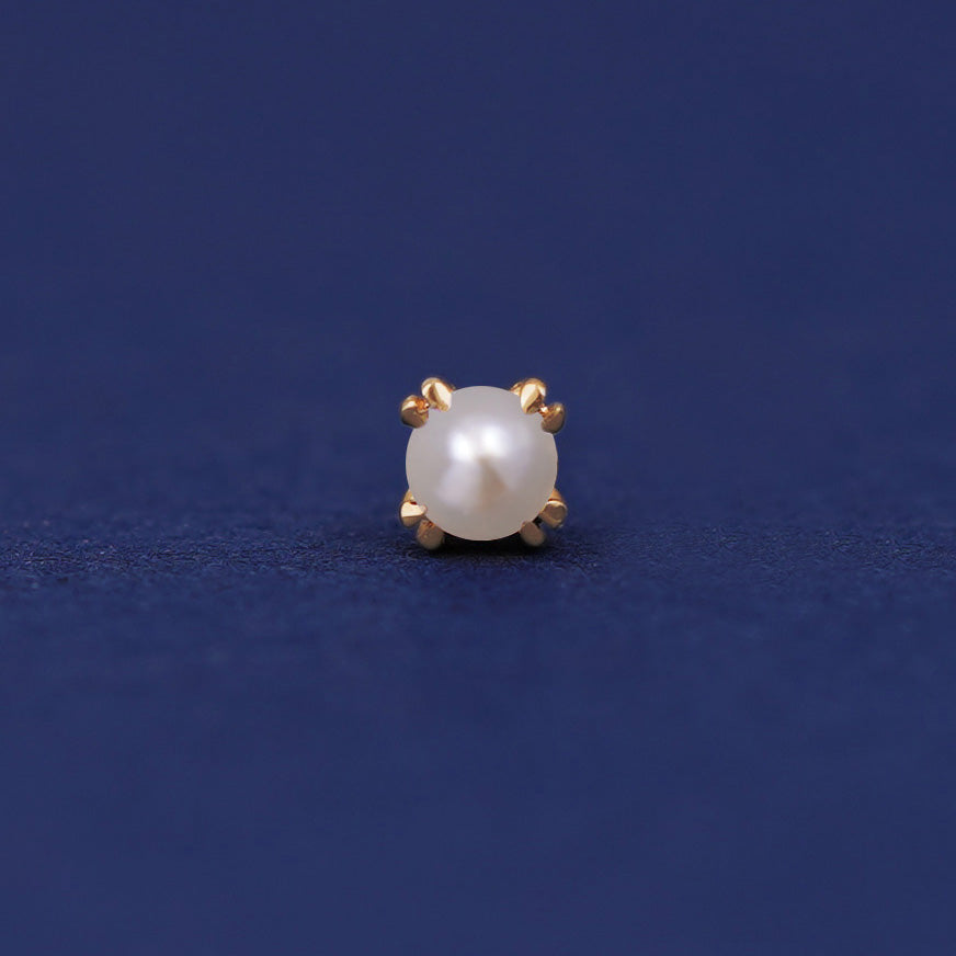 A 14 karat gold stud earring with a 3 millimeter round white freshwater cultured pearl