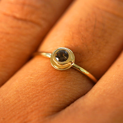 Close up view of a model's fingers wearing a yellow gold Coffee Cup Ring