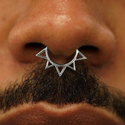 Close up view of a model's nose wearing a 14k white gold Sun Septum