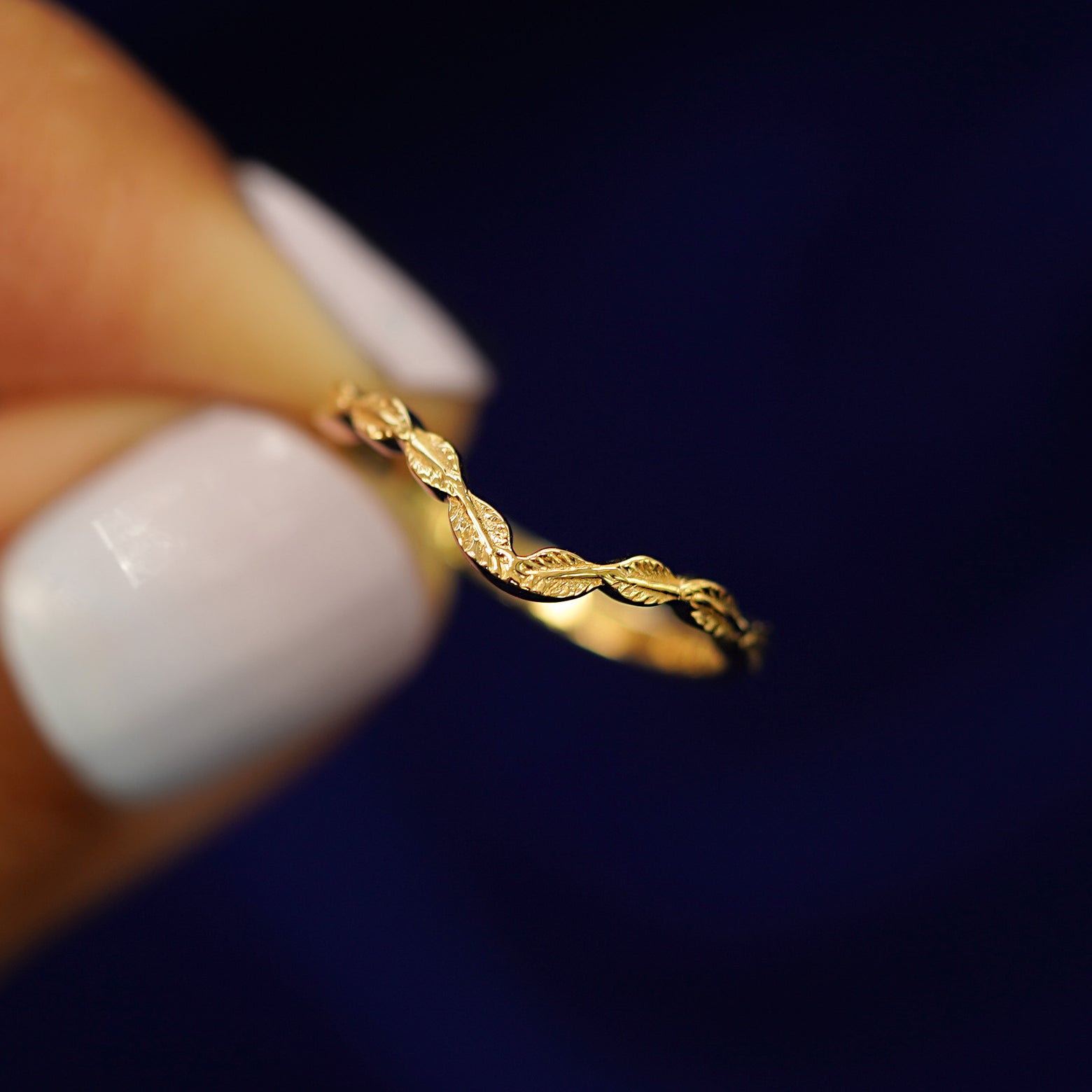 A model holding a Chevron Leaves Band tilted to show the side of the band