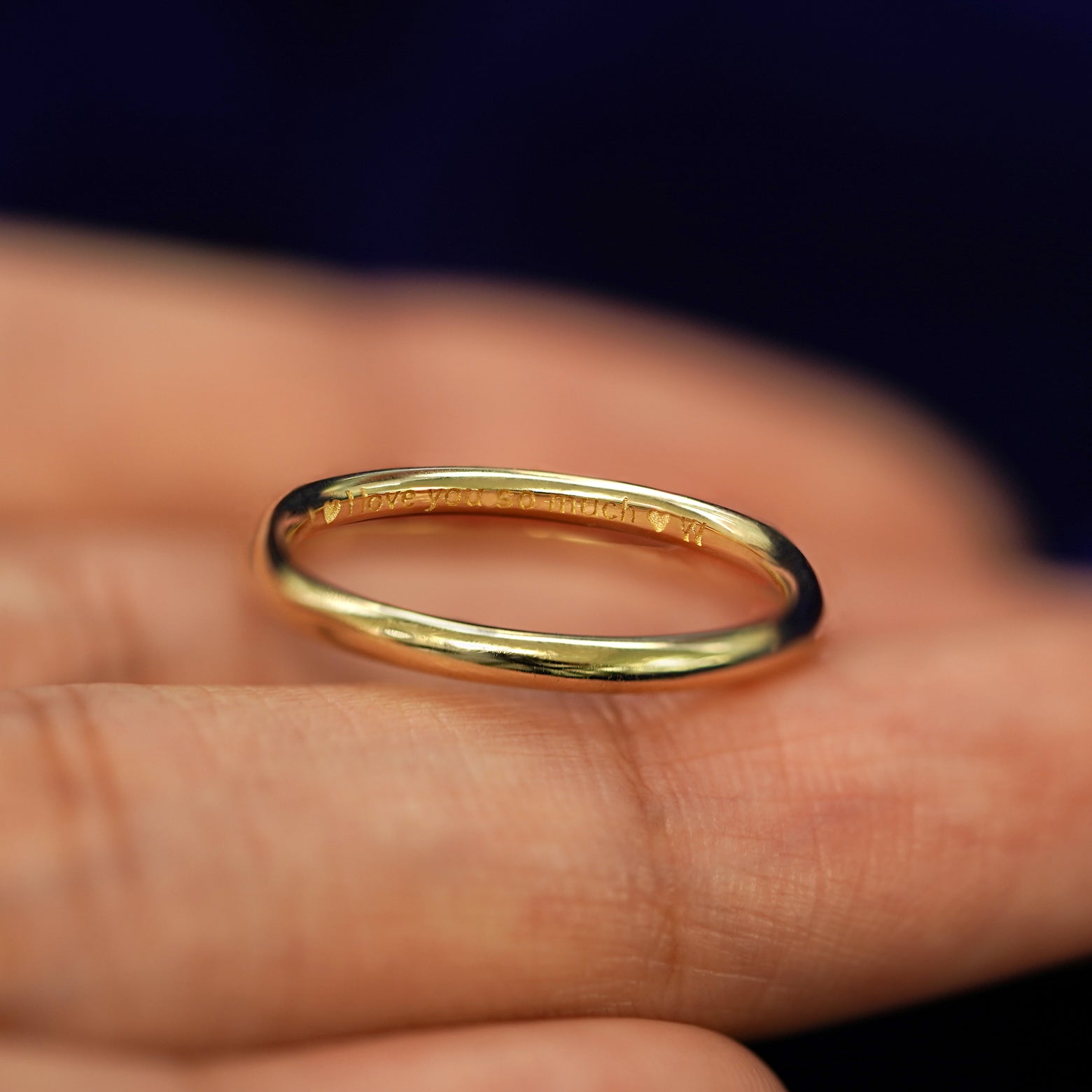 A 14k yellow gold Curvy Mirror Band with I Love You So Much engraved on the inside of the ring