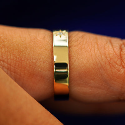 Side view of a Engraved Star Diamond Band on a model's finger