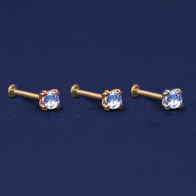 Three versions of the Aquamarine Flat Back Earring shown in options of rose, yellow, and white gold