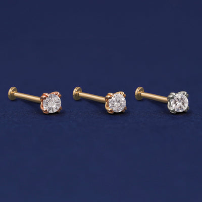 Three versions of the Moissanite Flat Back Earring shown in options of rose, yellow, and white gold