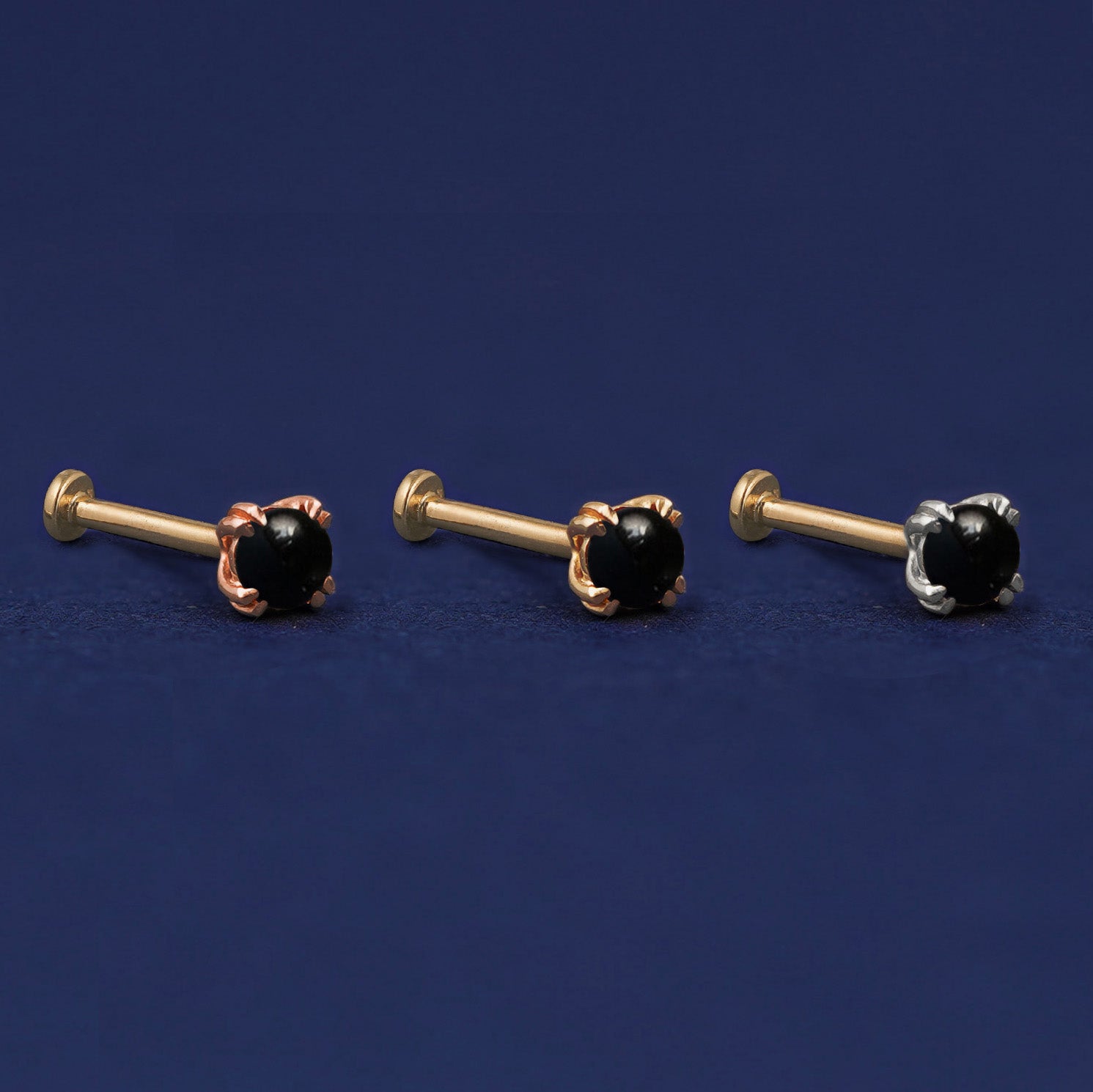 Three versions of the Onyx Flat Back Earring shown in options of rose, yellow, and white gold