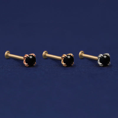 Three versions of the Onyx Flat Back Earring shown in options of rose, yellow, and white gold