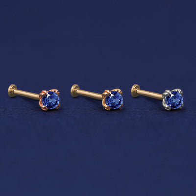 Three versions of the Sapphire Flat Back Earring shown in options of rose, yellow, and white gold