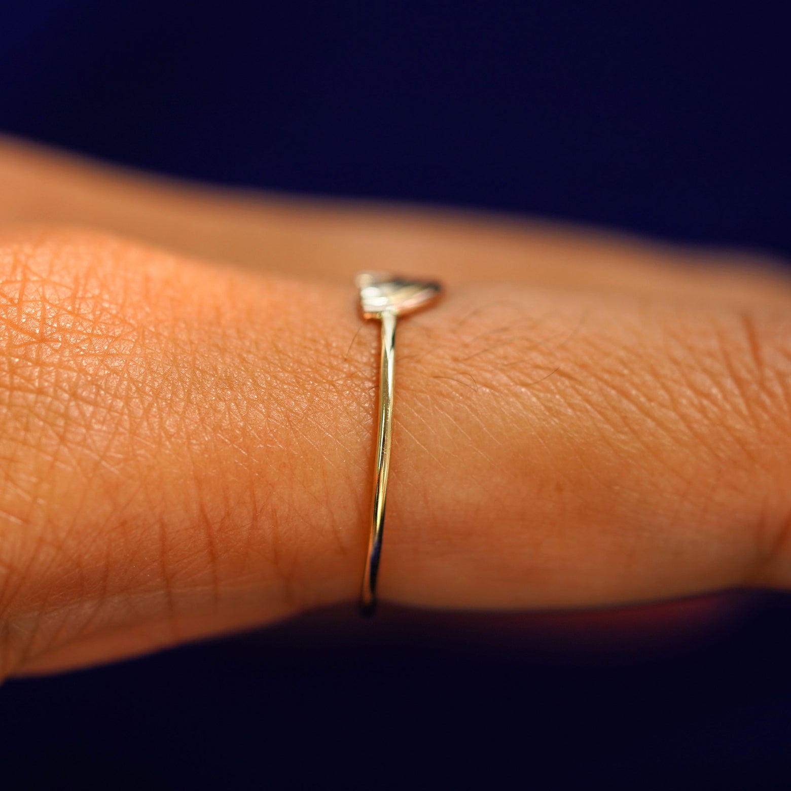 Side view of a Rainbow Ring on a model's finger