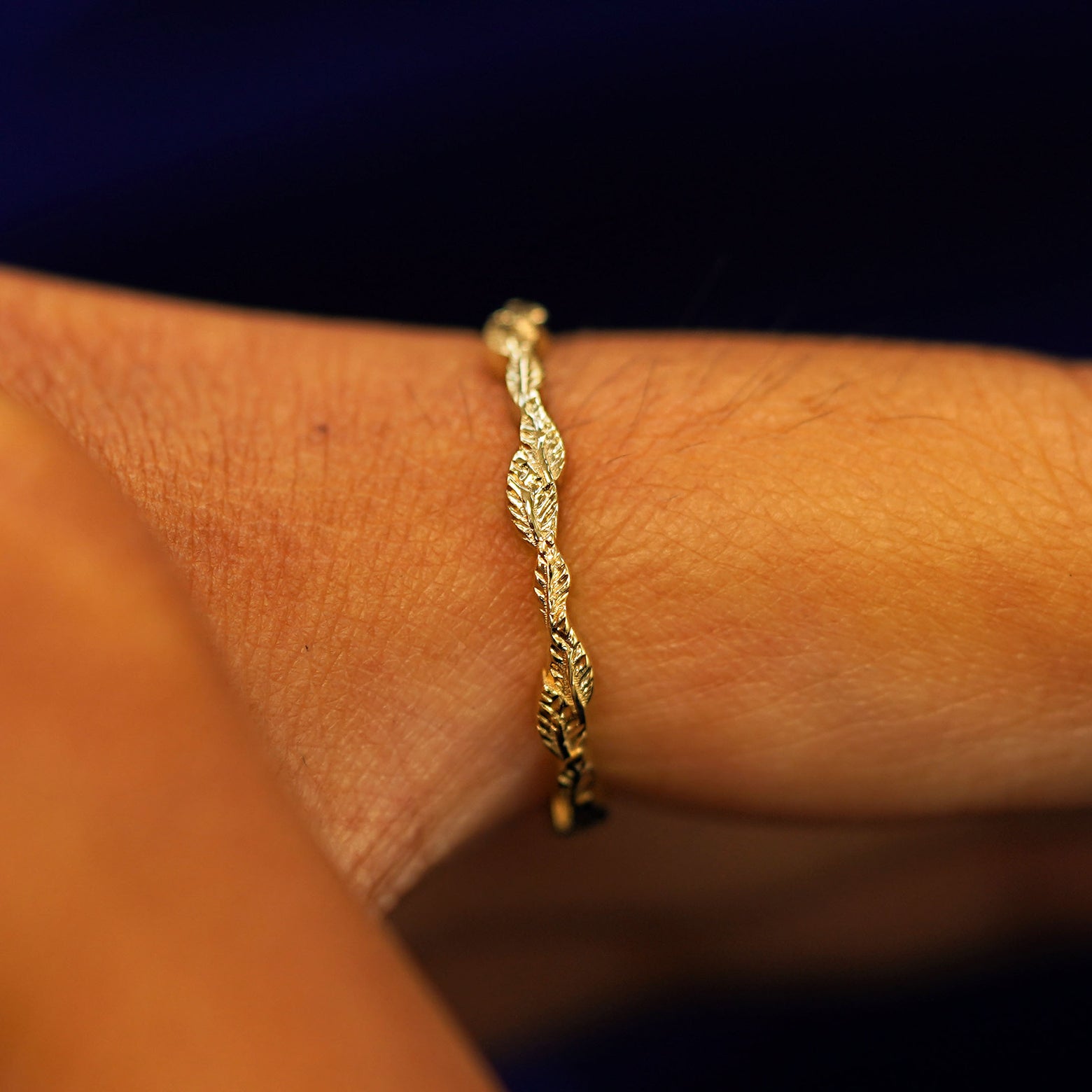 Side view of a Thin Leaves Band on a model's finger to show details