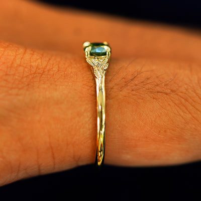 Side view of a Green Diamond Leaves Ring on a model's finger
