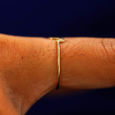 Side view of a Sagittarius Horoscope Ring on a model's finger