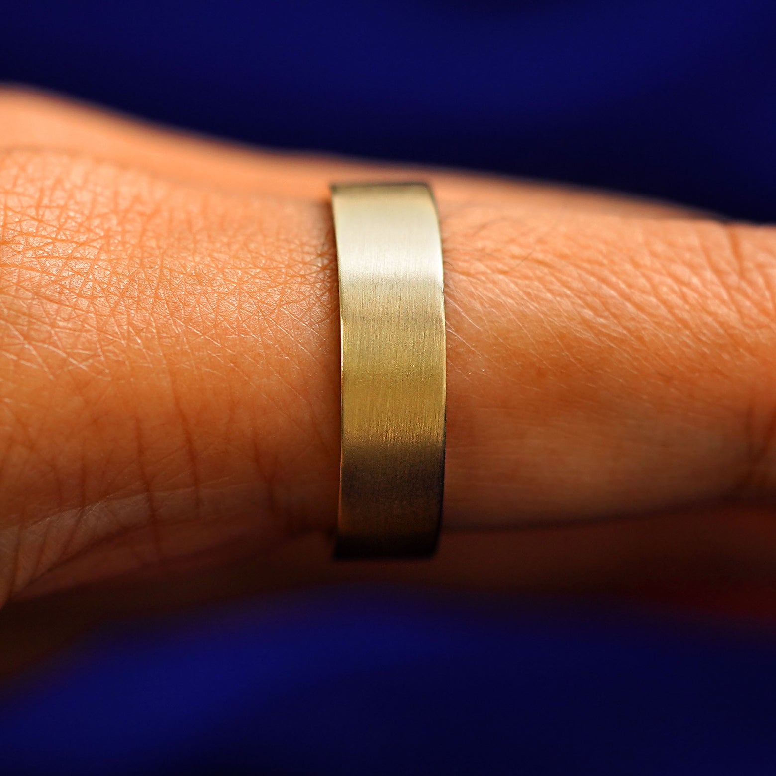 Side view of a Industrial Matte Band on a model's finger