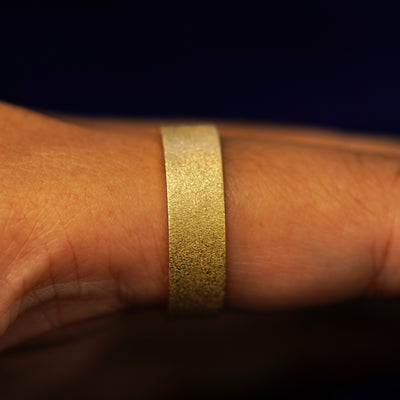 Side view of a Industrial Stardust Band on a model's finger