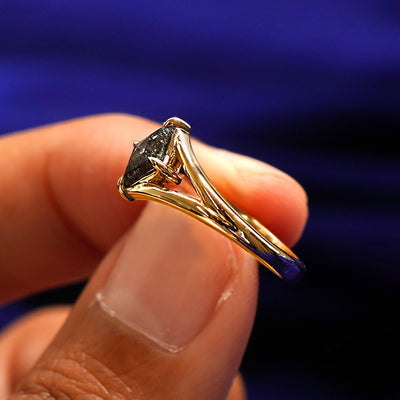 A model holding a Diamond Kite Ring tilted to show the details of the ring