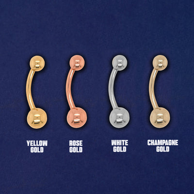 Four versions of the Large Curved Barbell Piercing in yellow, white, rose and champagne gold