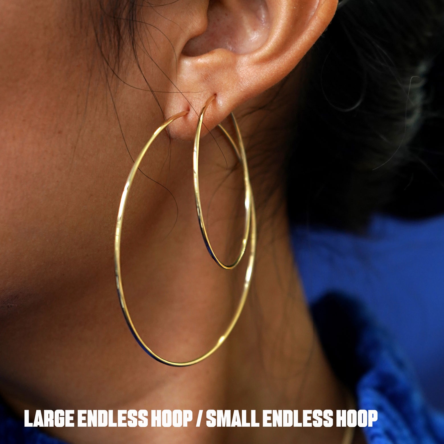 Close up view of a model's ear wearing a Large Endless Hoop and a Small Endless Hoop in two lobe piercings