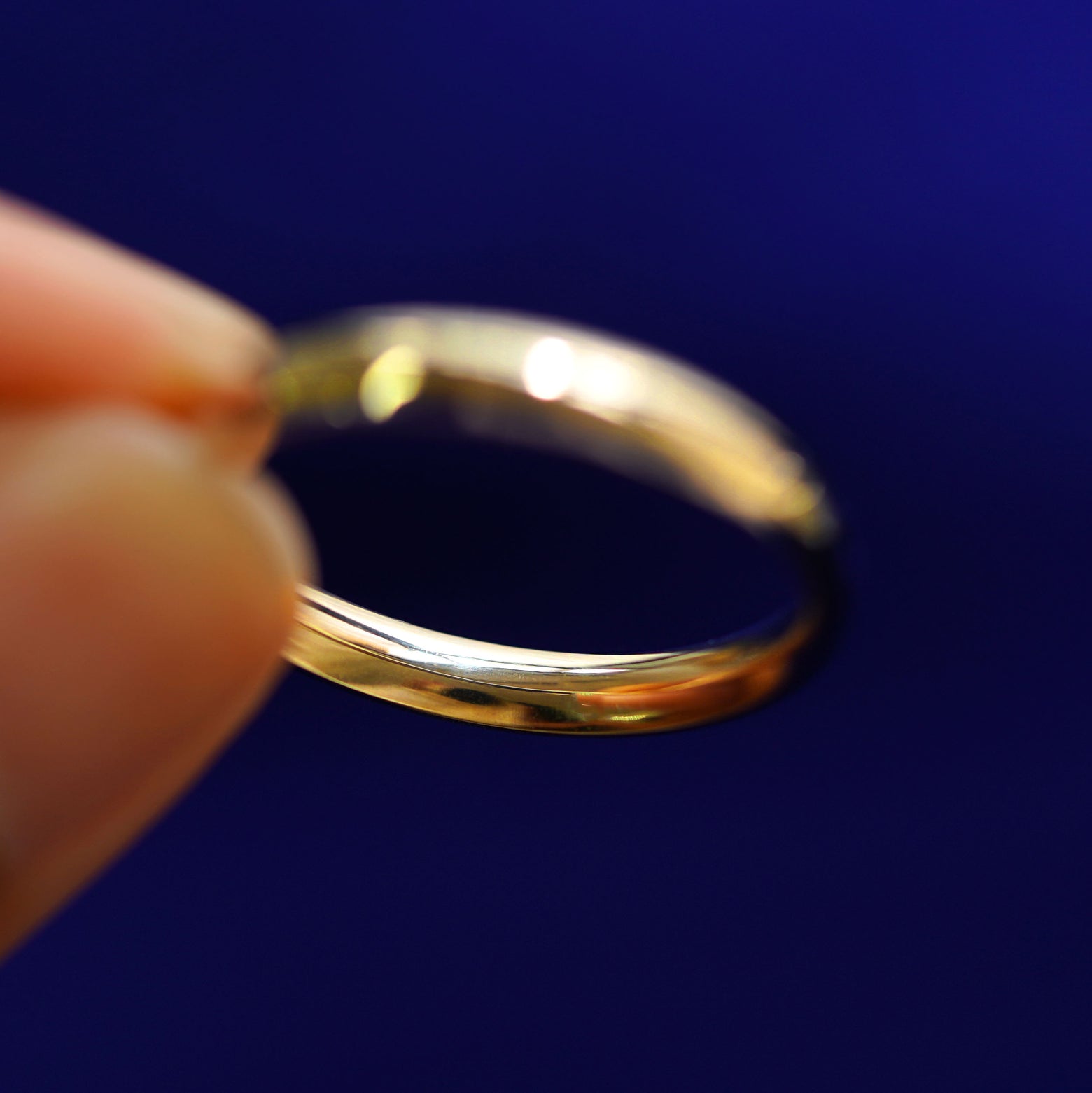 Underside view of a solid 14k gold Curvy Mirror Band