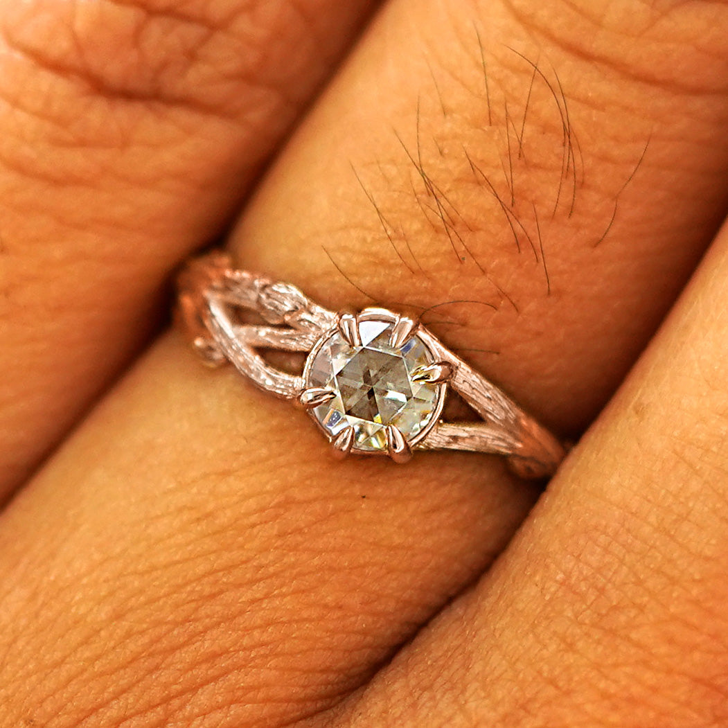 Close up view of a model's fingers wearing a 14k rose gold Moissanite Branches Ring