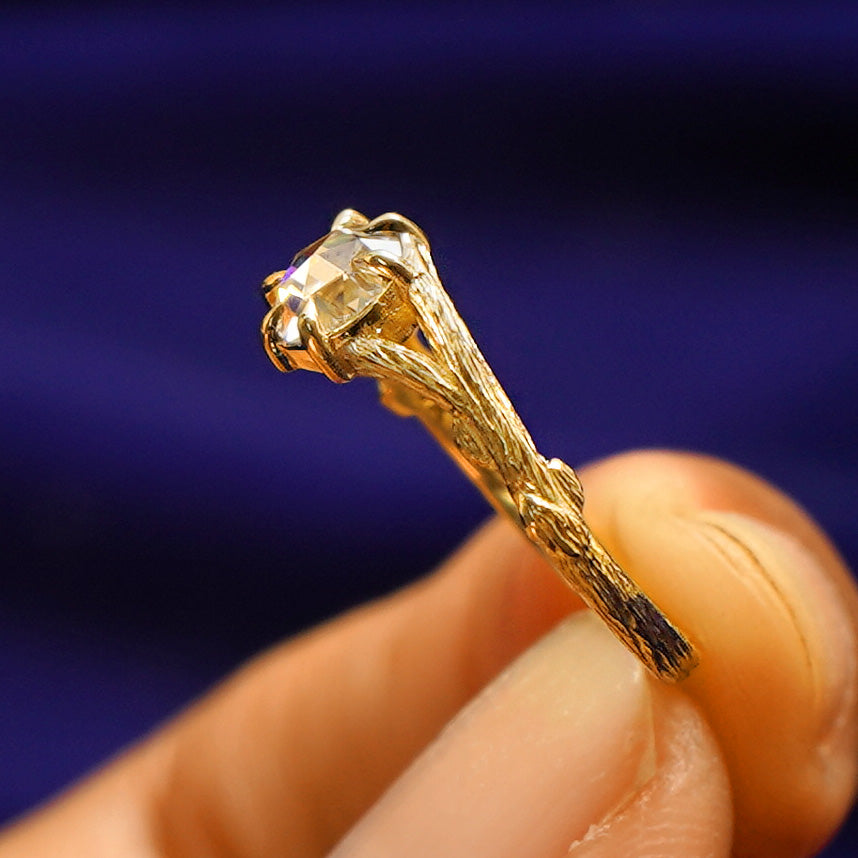 Side view of a Moissanite Branches Ring showing two tree branches going to the center stone