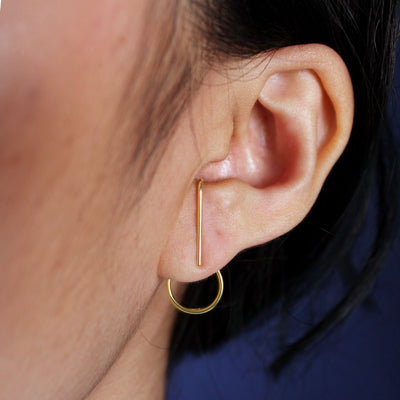 A model's ear wearing a solid 14k gold Open Circle Jacket with a Suspender Earring