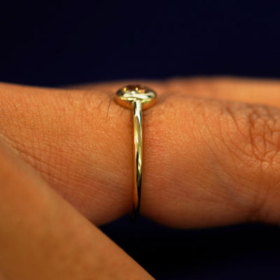 Side view of a Oval Champagne Diamond Ring on a model's finger to show details