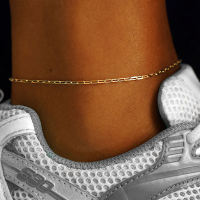 A model's ankle wearing a yellow gold Butch Anklet