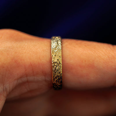 Side view of a Raw Band on a model's finger