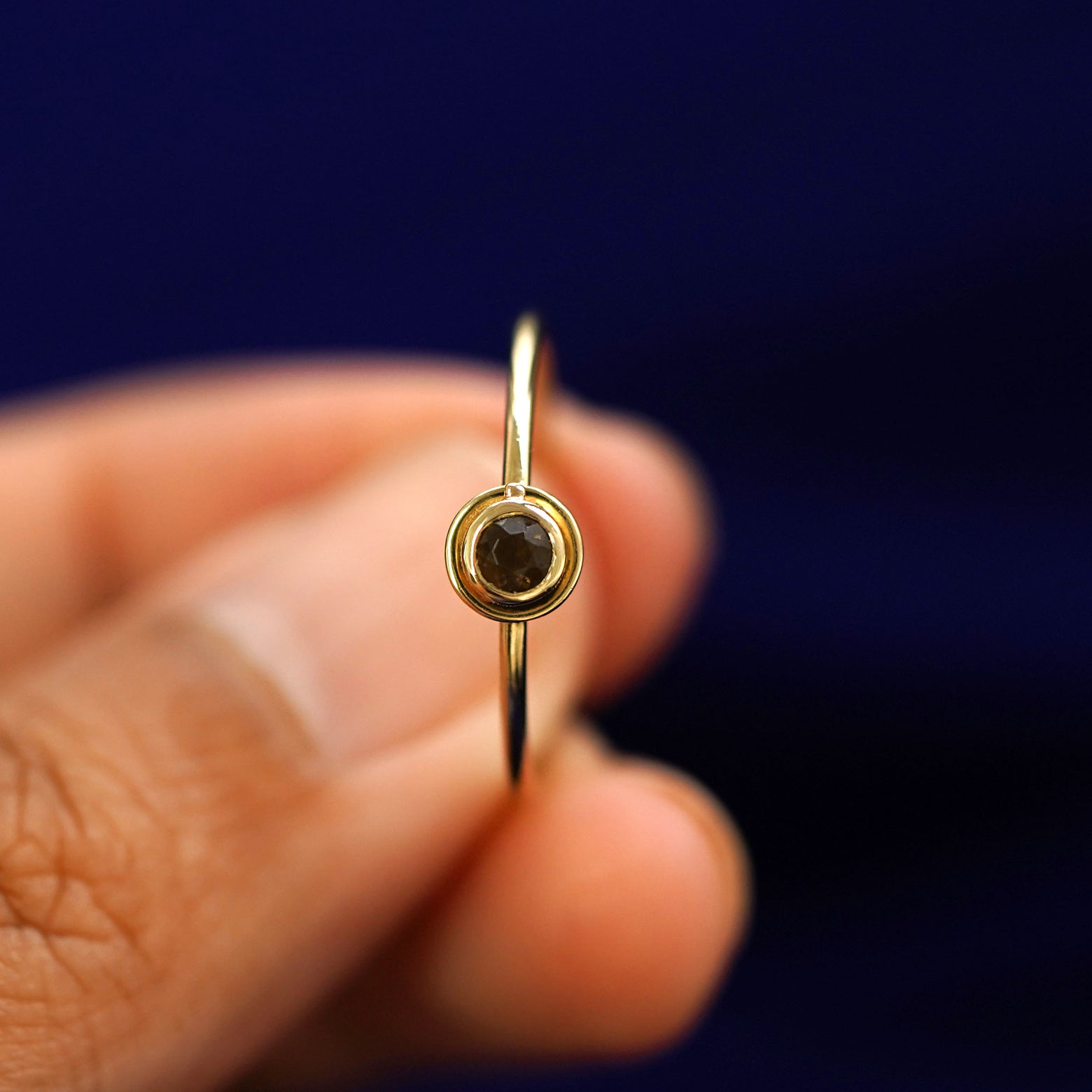 A model holding a Coffee Cup Ring straight on to show the detail of the stone