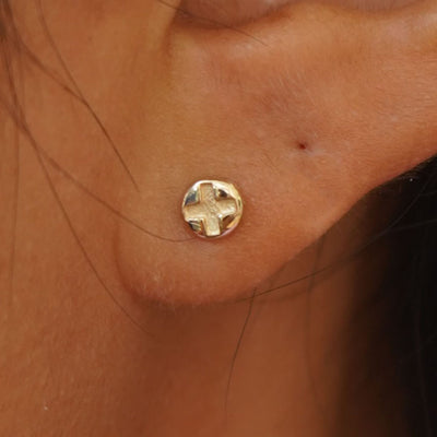 Close up view of a model's ear wearing a yellow gold Screw Earring