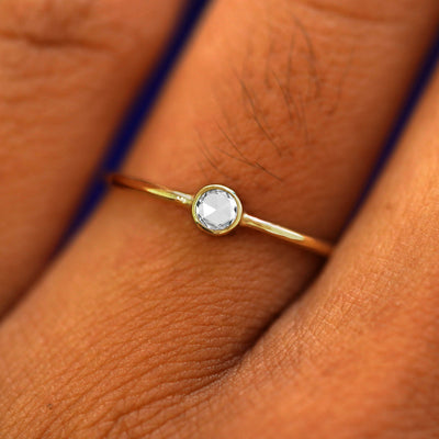 Close up view of a model's fingers wearing a 14k yellow gold Rose Cut Diamond Ring