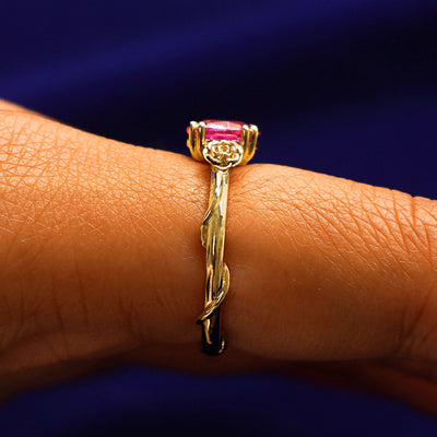 Side view of a Pink Sapphire Roses Ring on a model's finger
