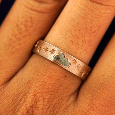 Close up view of a model's fingers wearing a 14k rose gold Cloud Diamond Band