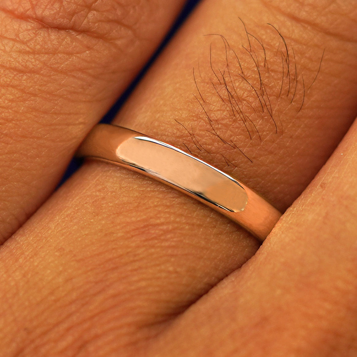 Close up view of a model's fingers wearing a 14k rose gold Mix Mirror Band