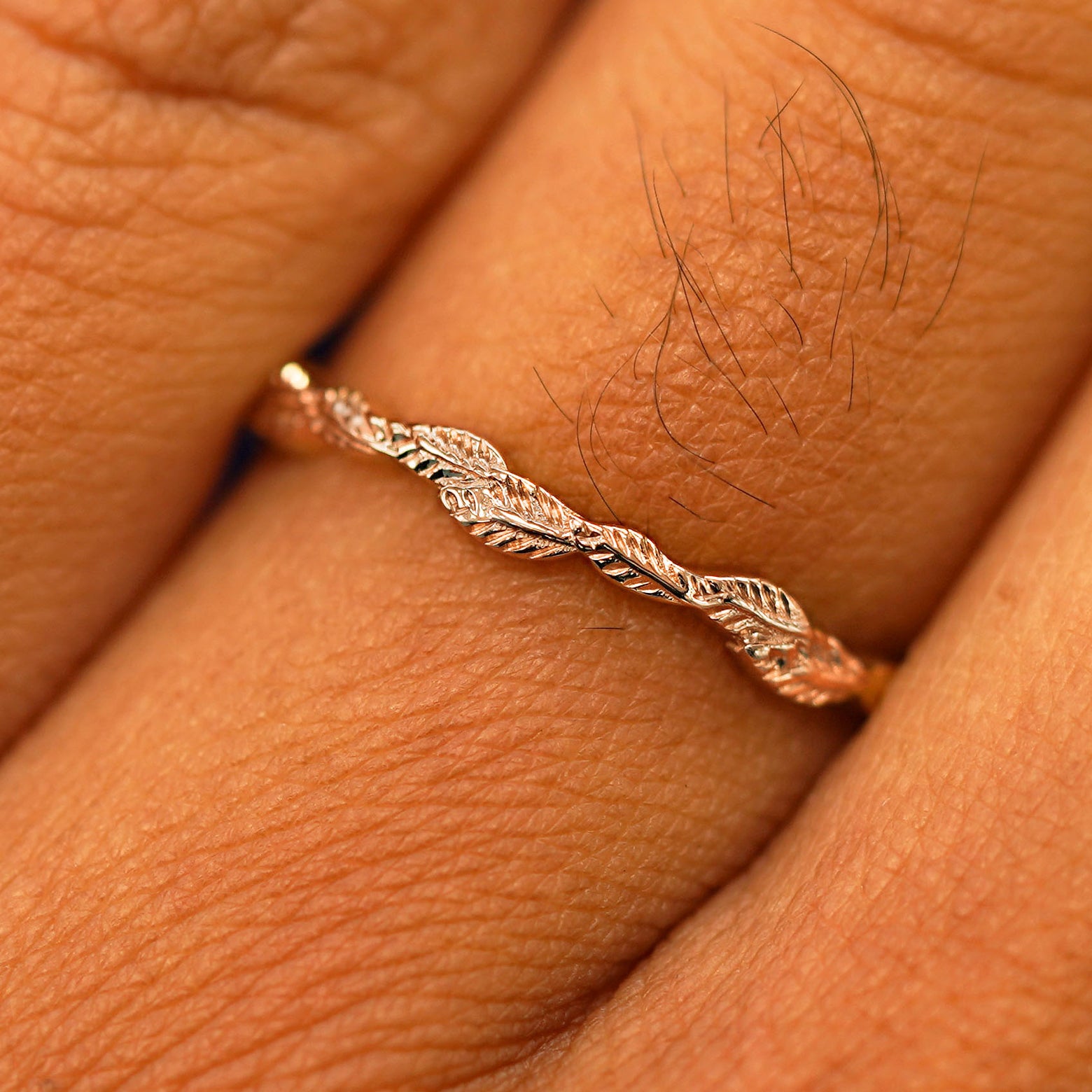 Close up view of a model's fingers wearing a 14k white gold Thin Leaves Band