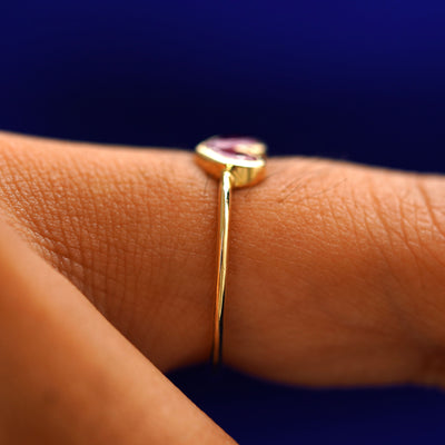 Side view of a Ruby Heart Ring on a model's finger