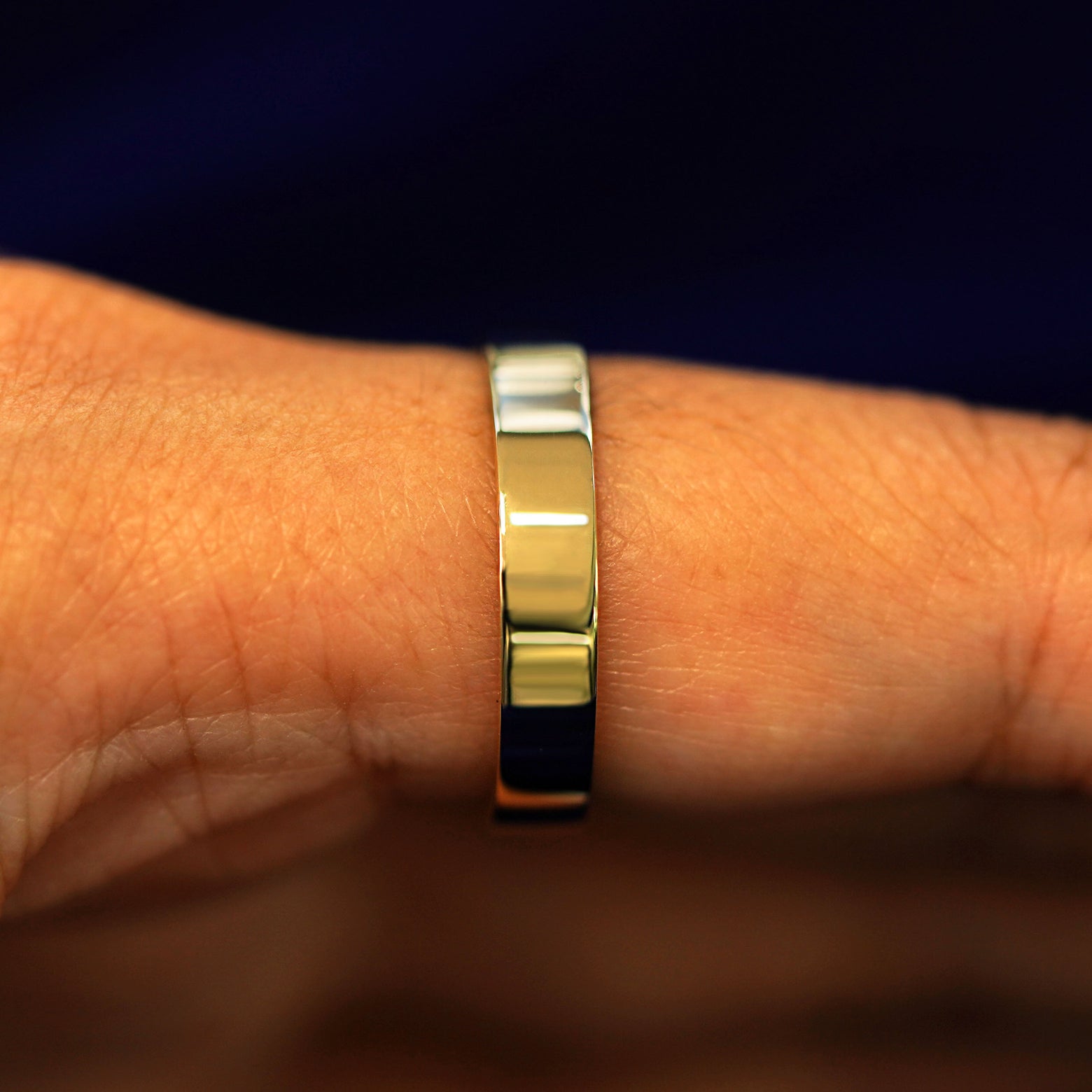 Side view of a Salt and Pepper Baguette Diamond Band on a model's finger