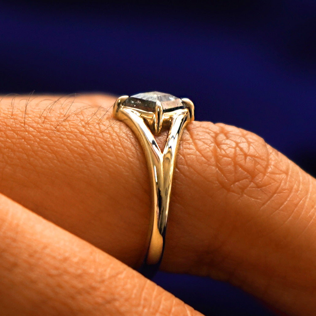 Side view of a Diamond Kite Ring on a model's finger to show the hidden halo