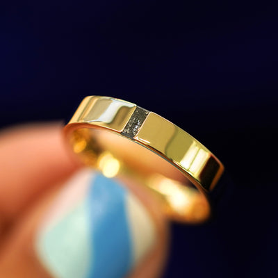 A model holding a Salt and Pepper Baguette Diamond Band tilted to show the details of the diamonds