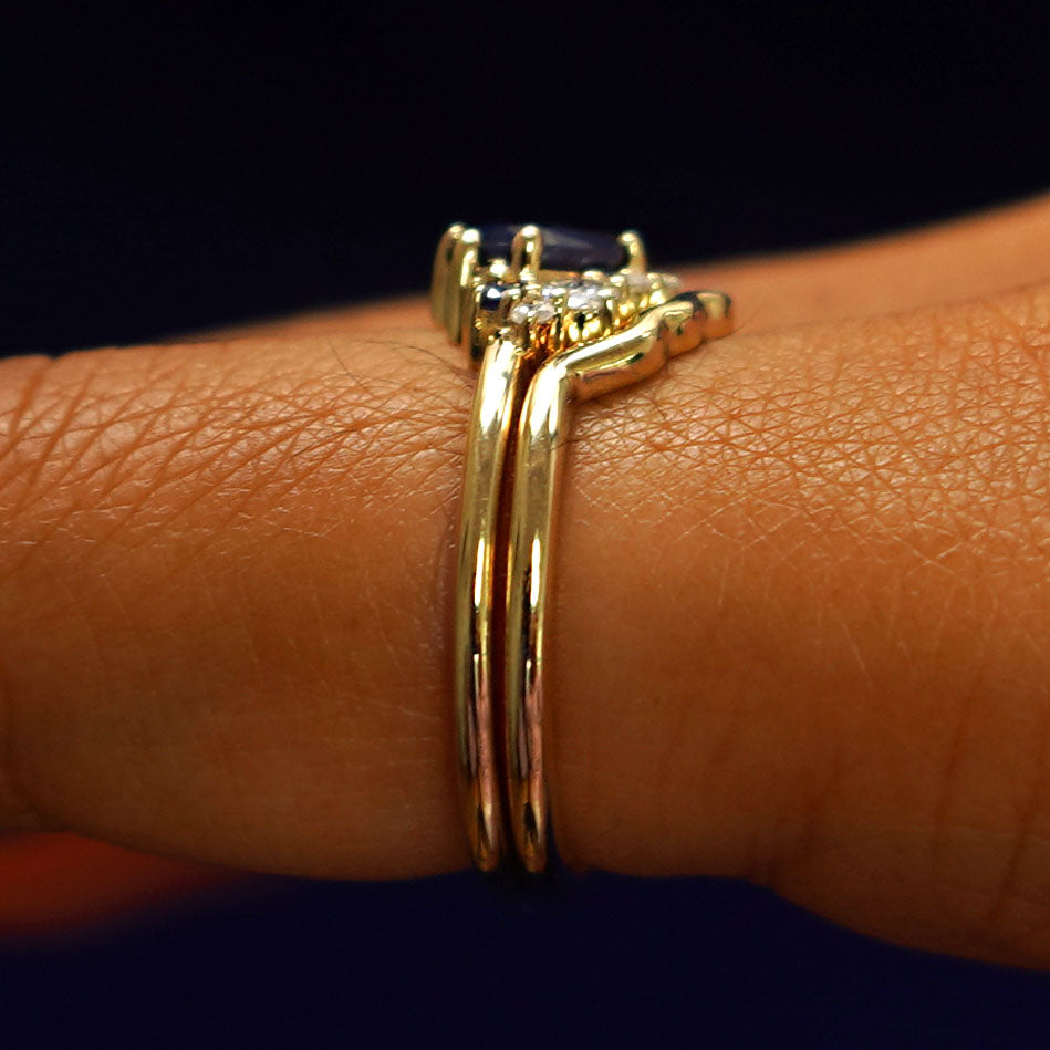 Alternate side view of an Sapphire and Diamond Cluster Ring Set on a model's finger