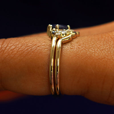 Alternate side view of an Sapphire and Diamond Cluster Ring Set on a model's finger
